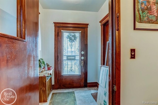 doorway with carpet floors