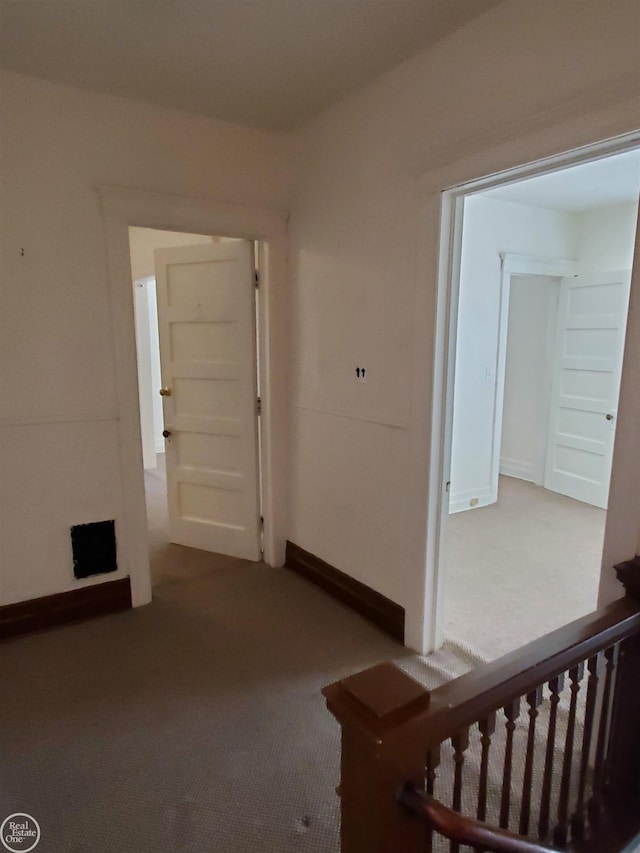 hall with stairway and carpet flooring