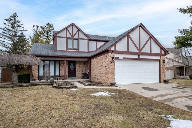 tudor home featuring a garage, brick siding, driveway, and stucco siding