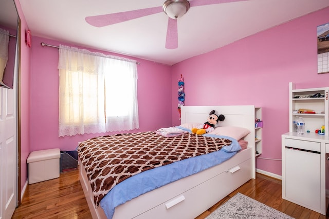 bedroom featuring ceiling fan, wood finished floors, and baseboards