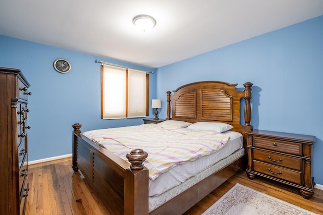 bedroom featuring baseboards and wood finished floors