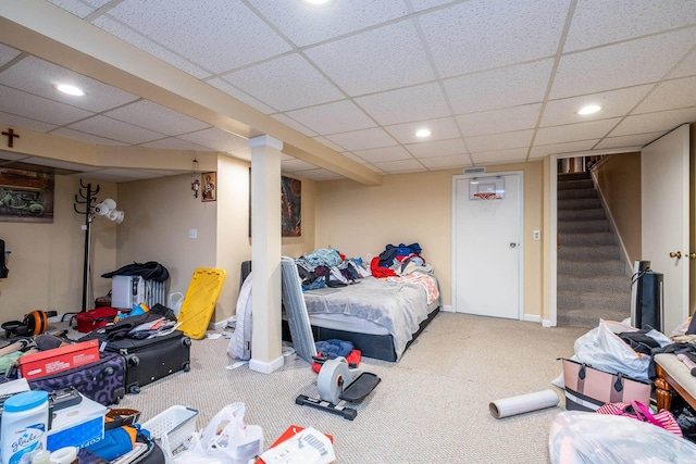 carpeted bedroom featuring recessed lighting, a paneled ceiling, and baseboards