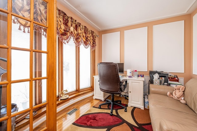 home office with light wood finished floors and visible vents