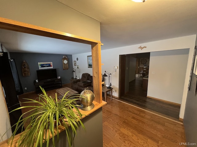 interior space with wood finished floors and baseboards