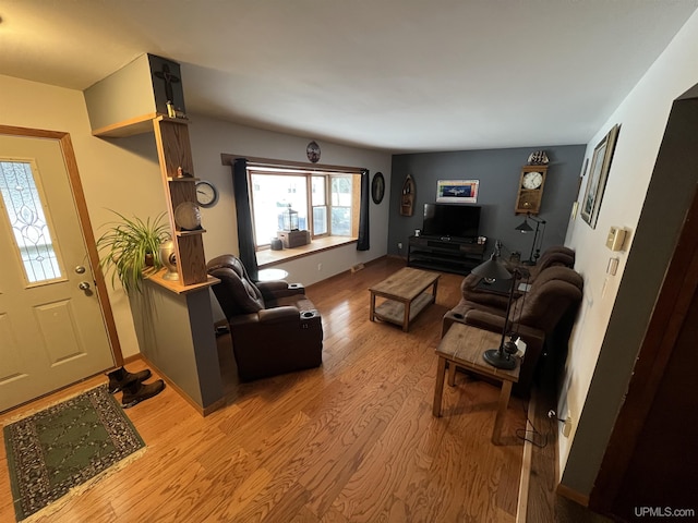 living area featuring light wood-style flooring and baseboards