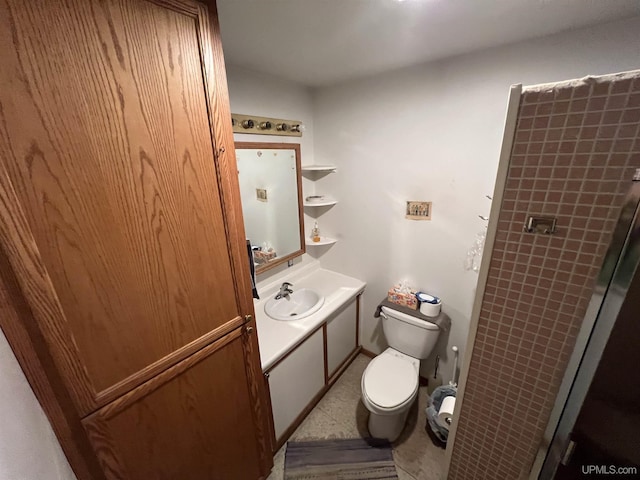 bathroom with vanity, walk in shower, and toilet