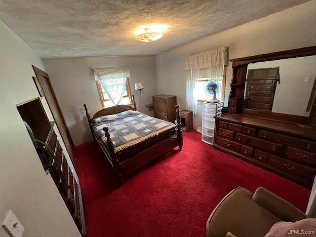 bedroom featuring carpet floors and a textured ceiling