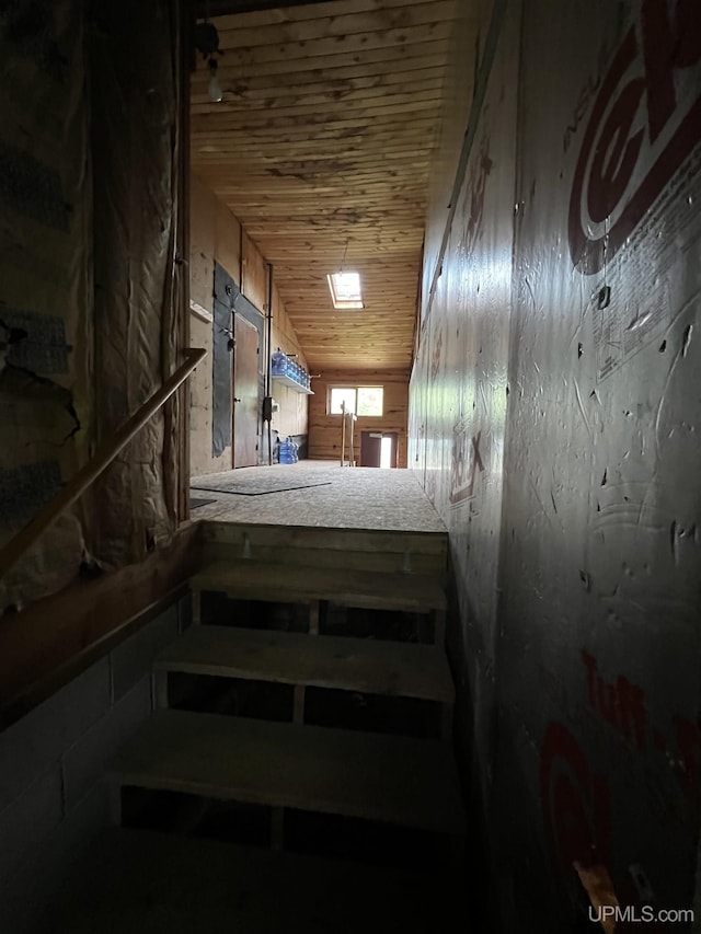 stairway featuring lofted ceiling and wooden ceiling