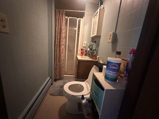 bathroom with toilet, a stall shower, a baseboard heating unit, and vanity