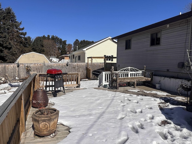 snow covered deck with fence