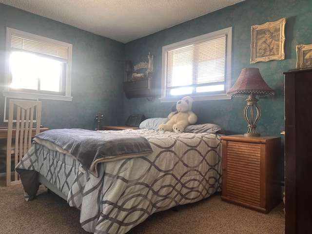 carpeted bedroom featuring a textured ceiling