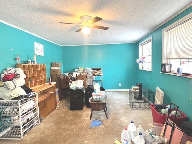 misc room featuring ceiling fan and a textured ceiling