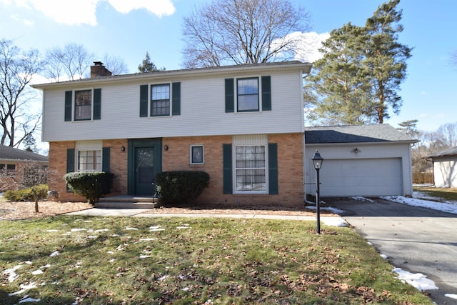 colonial-style house featuring a garage, brick siding, concrete driveway, a chimney, and a front yard