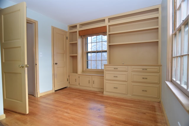 unfurnished bedroom with light wood-style floors and baseboards