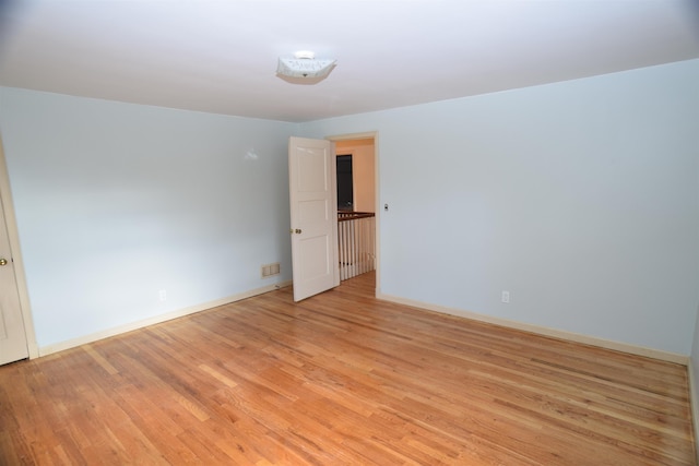 empty room with light wood-style floors and baseboards