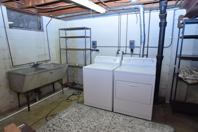 clothes washing area with laundry area, independent washer and dryer, and a sink