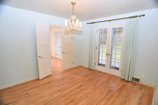 unfurnished dining area featuring light wood finished floors, french doors, visible vents, and baseboards