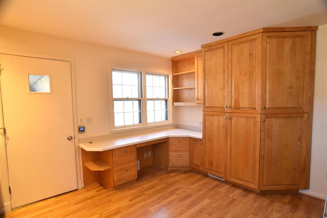 unfurnished office with light wood finished floors, built in study area, visible vents, and recessed lighting