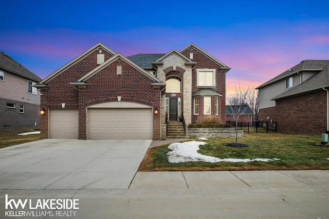 traditional-style home with an attached garage, a front lawn, concrete driveway, and brick siding