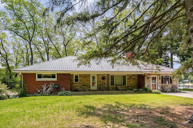 7836 W Perch Lake Dr, Lake, MI 48632 - ranch-style house featuring metal roof, stone siding, and a chimney