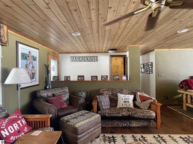 cinema room featuring a ceiling fan and wood ceiling