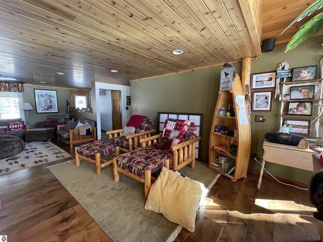 bedroom with wood ceiling and wood-type flooring