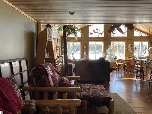 sunroom featuring vaulted ceiling and wood ceiling