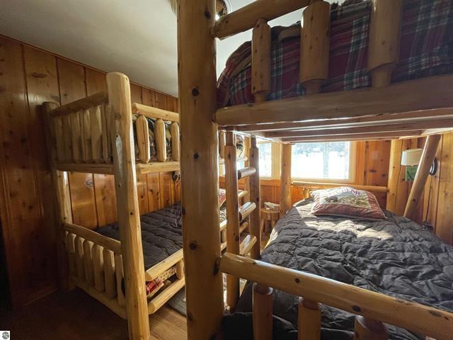 bedroom with wooden walls