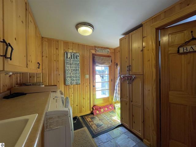 interior space with wooden walls and a sink