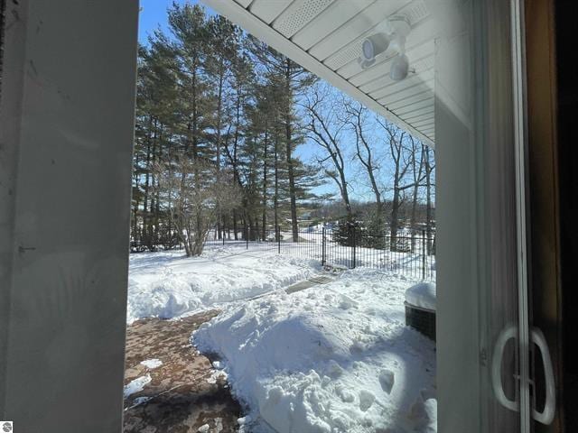 yard layered in snow with fence