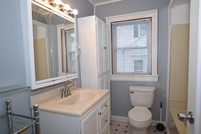 full bathroom featuring a bathing tub, vanity, toilet, and tile walls