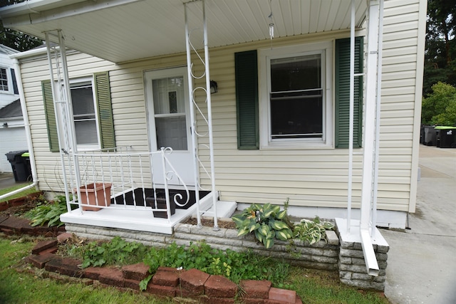 view of exterior entry with a porch