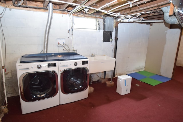 washroom with laundry area, separate washer and dryer, and a sink