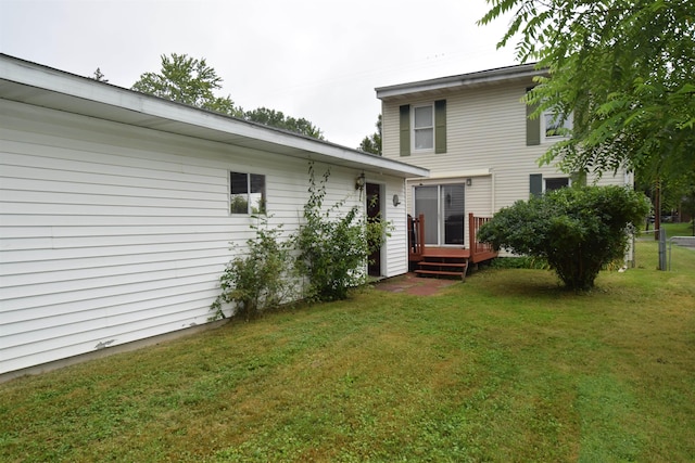 rear view of house featuring a yard