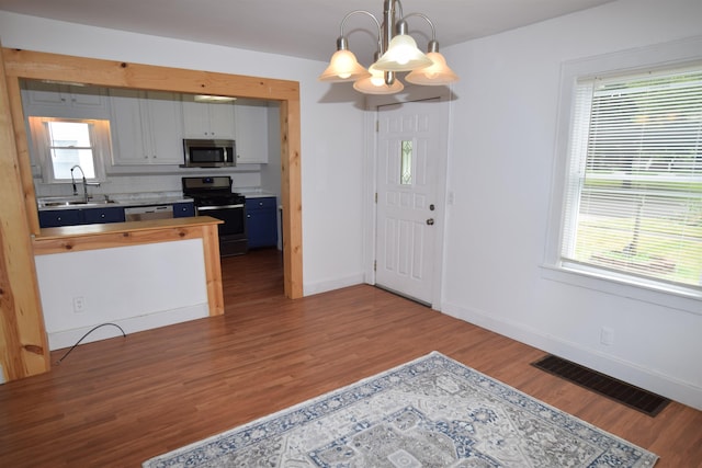 kitchen featuring appliances with stainless steel finishes, a sink, visible vents, and a healthy amount of sunlight