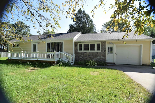 ranch-style home with driveway, stone siding, an attached garage, and a front yard