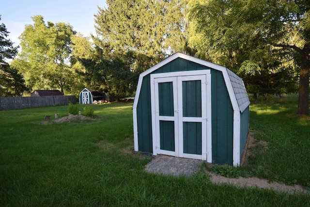 view of shed featuring fence