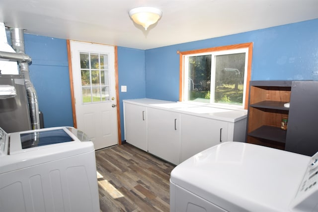 washroom featuring a wealth of natural light, laundry area, washer and clothes dryer, and dark wood-style flooring