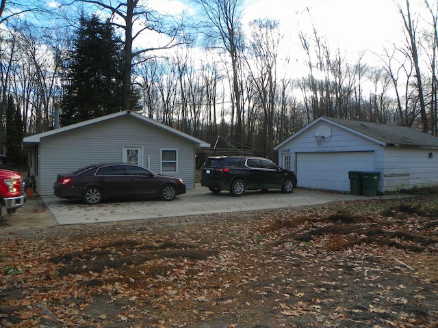 view of side of home with a garage and an outdoor structure