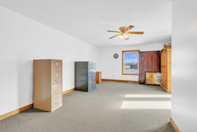 unfurnished bedroom with carpet, a ceiling fan, and baseboards