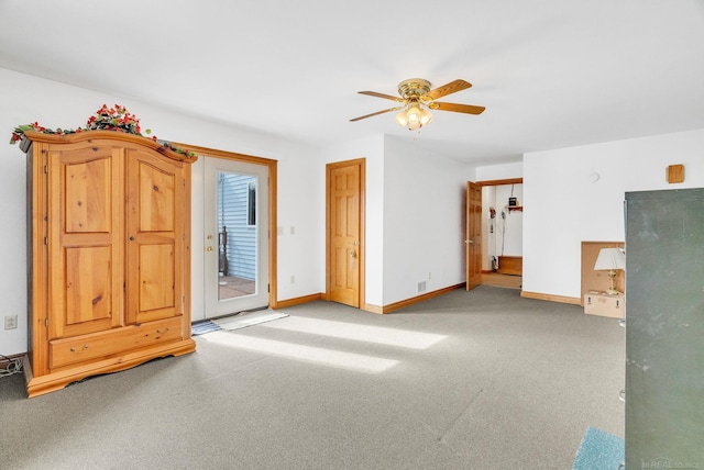 unfurnished bedroom featuring access to exterior, baseboards, a ceiling fan, and light colored carpet