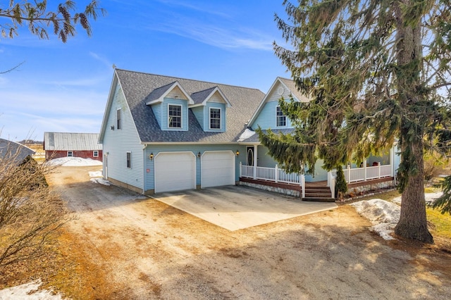 view of front of home featuring an attached garage, driveway, a porch, and a shingled roof