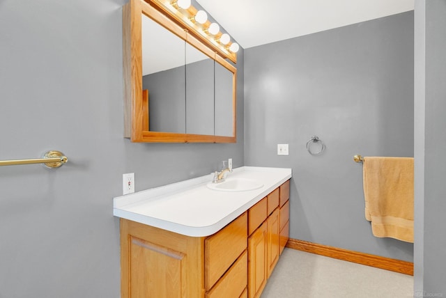 bathroom featuring baseboards and vanity