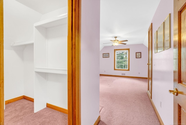 corridor featuring carpet, lofted ceiling, and baseboards