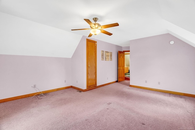 bonus room featuring lofted ceiling, ceiling fan, carpet flooring, visible vents, and baseboards