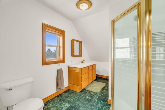 bathroom featuring vaulted ceiling, vanity, toilet, and baseboards