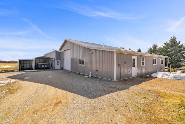 exterior space featuring a carport and gravel driveway