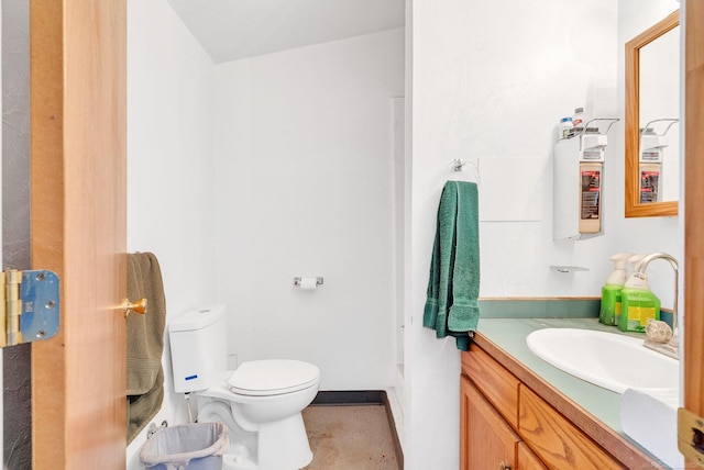 bathroom featuring toilet, baseboards, and vanity