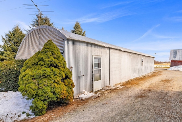 view of side of home featuring an outdoor structure