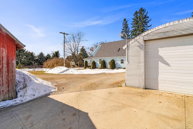 view of yard featuring driveway and a garage